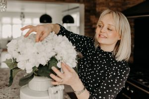 Essex wedding planner Hayley Jayne arranging flowers at wedding