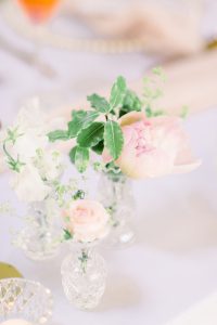 Flowers in small bud vases on wedding top table | Essex Wedding Planner