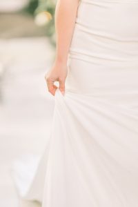 Bride holding dress walking down the aisle | Essex wedding planner