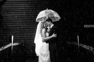 Bride & Groom in the rain with raindrops | Essex Wedding Planner