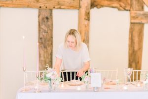 Hayley Jayne Weddings & Events setting up a wedding table | Essex Wedding Planner