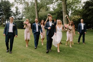 Bridal party walking across field | Essex wedding planner