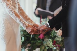 Bride & Groom holding hands during wedding ceremony | Luxury Essex Wedding Planner