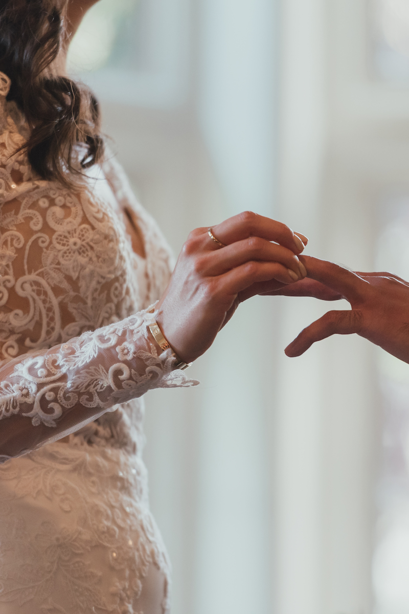 Bride & groom exchanging rings | UK luxury wedding