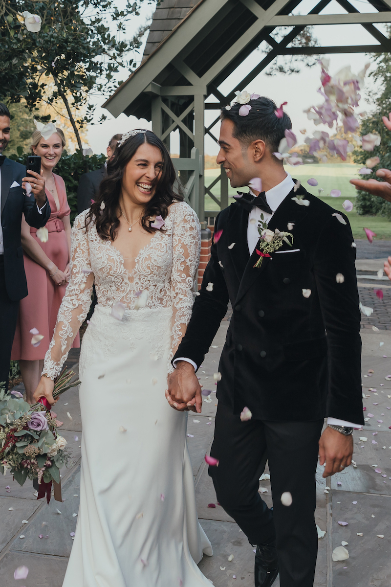 Bride and groom with confetti | Luxury Essex Wedding