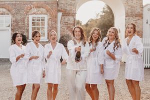 Bride & bridesmaids celebrating on wedding morning | Essex wedding planner 