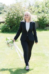 Luxury UK wedding planner walking with elegant wedding bouquet | UK luxury wedding planner